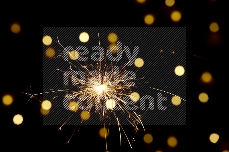 Sparkler candle with yellow light bokeh background