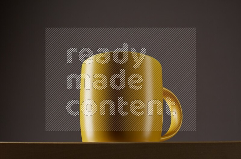 Low angle shot of a yellow cup on grey background