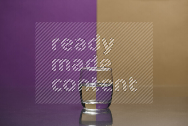 The image features a clear glassware filled with water, set against purple and beige background