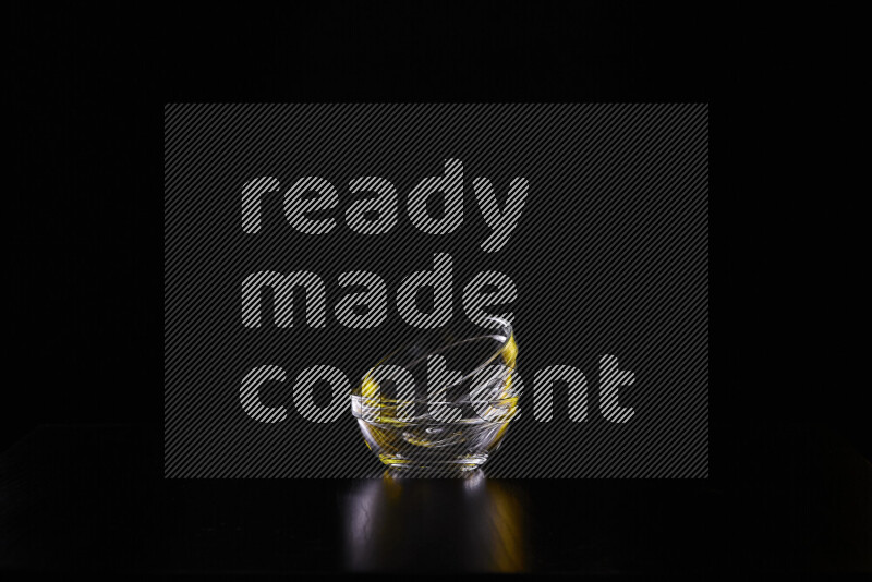 Glassware with rim light in yellow and white against black background