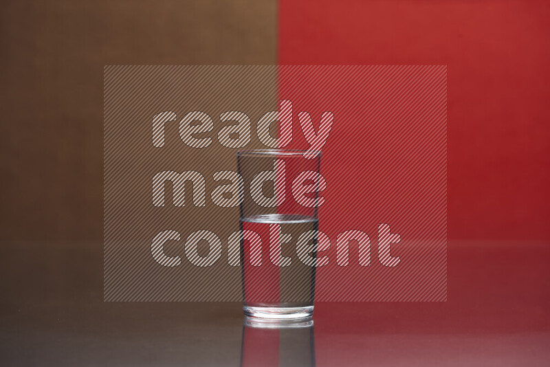 The image features a clear glassware filled with water, set against brown and red background