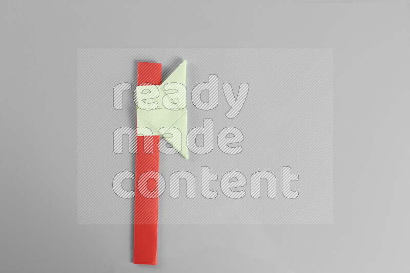 Origami axe on grey background