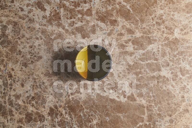 A multicolored pottery bowl on beige marble background