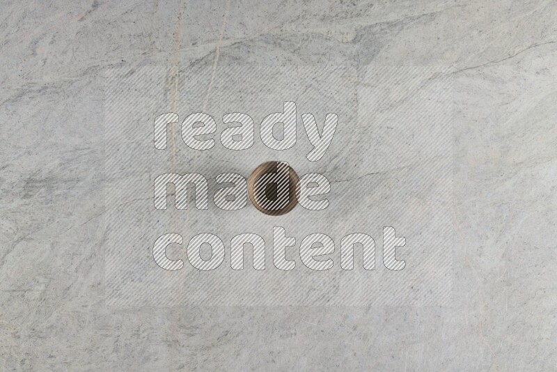 A multicolored pottery Cup on grey marble background