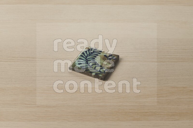A decorative coaster on light wooden background