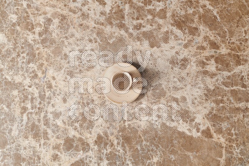 A pottery cup on beige marble background