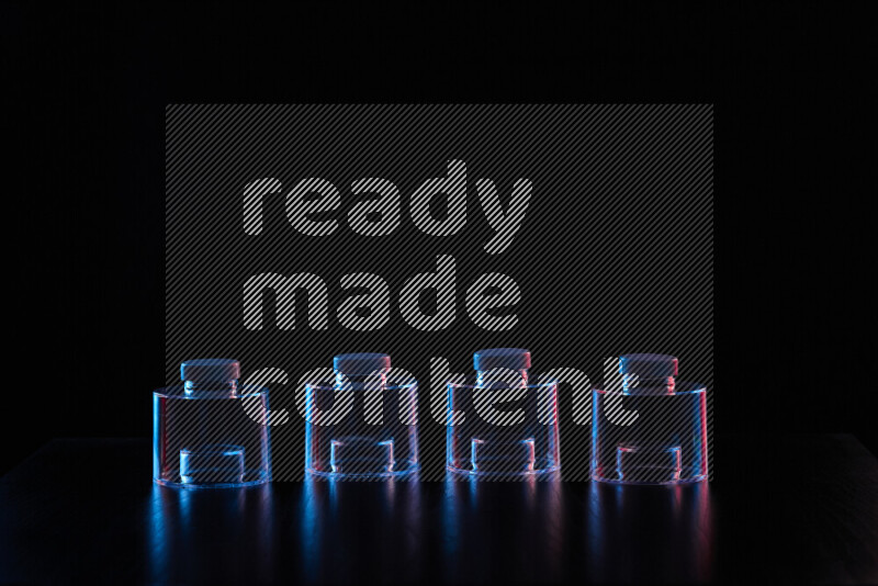 Glassware with rim light in red and blue against black background