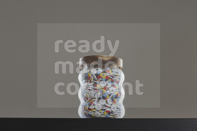 Buttons in a glass jar on black background