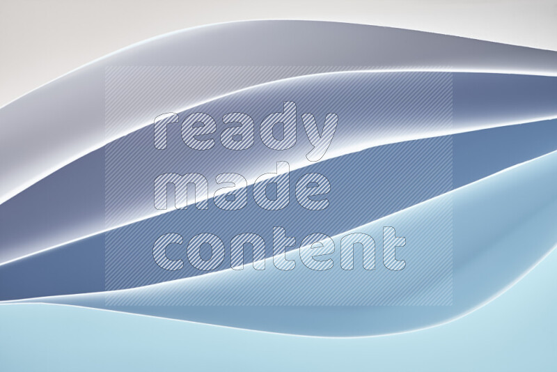 This image showcases an abstract paper art composition with paper curves in blue gradients created by colored light