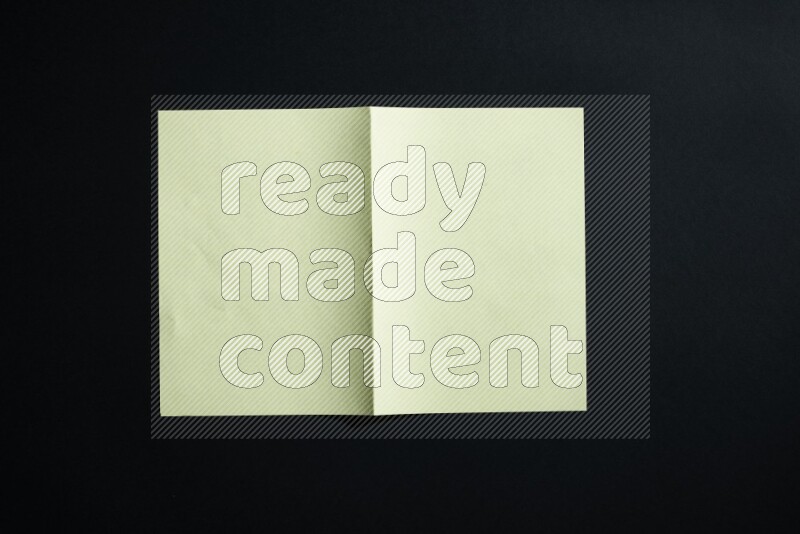 Yellow paper sheet on black background