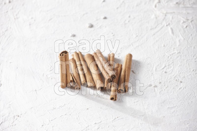 Cinnamon sticks on a textured white background