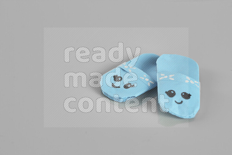 Origami slippers on grey background