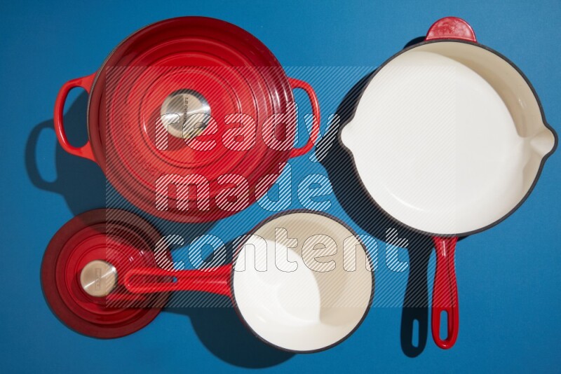 red and white pan and pot on blue background