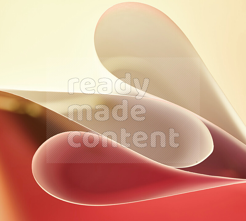 An abstract art of paper folded into smooth curves in yellow and red gradients