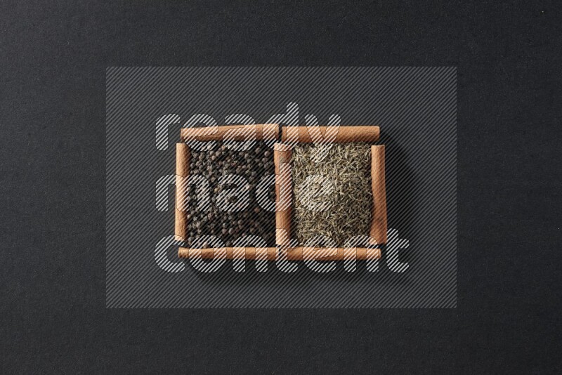 2 squares of cinnamon sticks full of black peppers and cumin on black flooring
