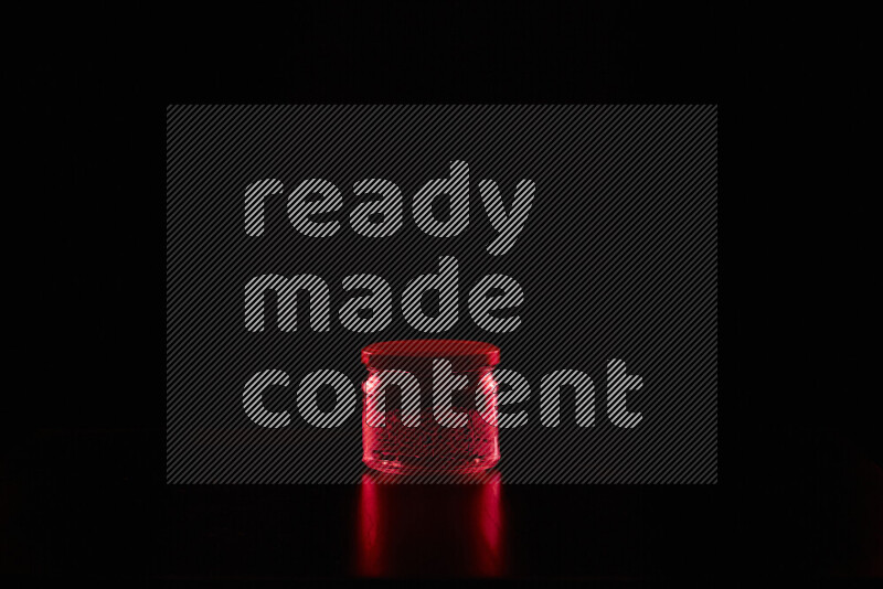 Glassware with rim light in red against black background