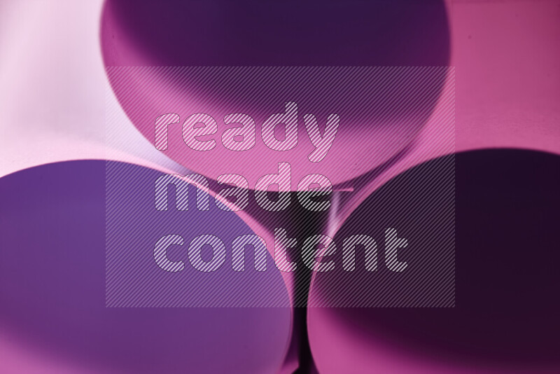 The image shows an abstract paper art with circular shapes in varying shades of pink
