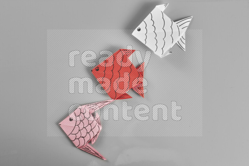 Origami fish on grey background