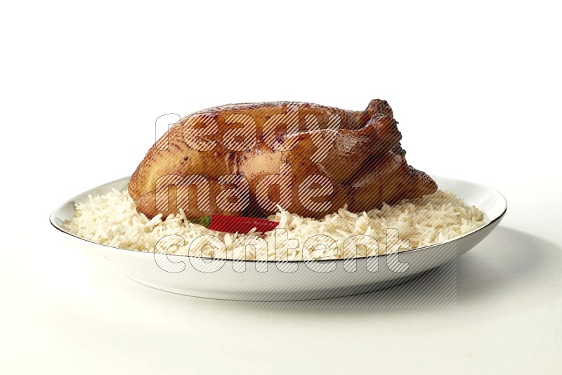 white  basmati Rice with  whole roasted chicken  on a white plate with a silver rim direct  on white background