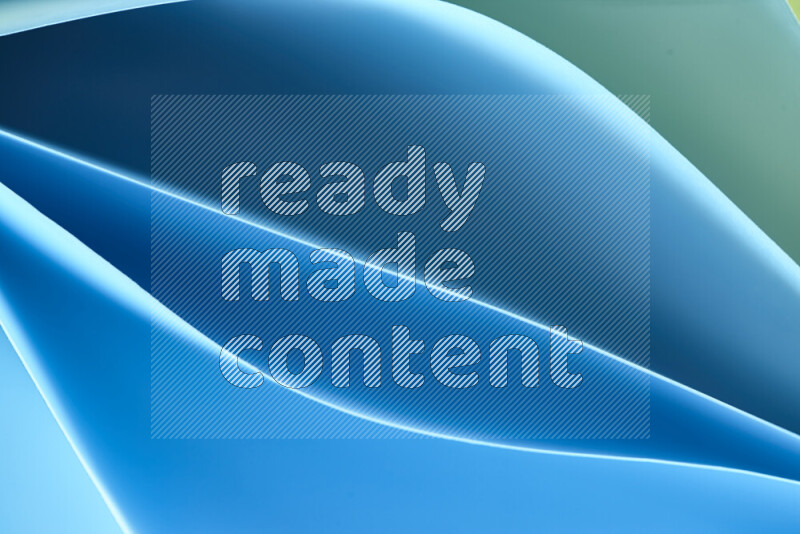 هذه الصورة تعرض تكوين فن الورق التجريدي مع منحنيات ورقية بتدرجات اللون الأخضر والأزرق المكونه بواسطة الضوء الملون