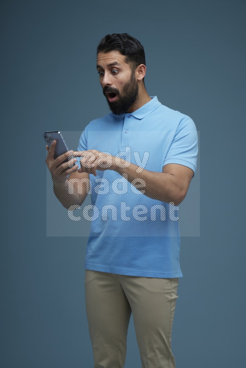 A man Swiping in a blue background wearing a Blue shirt
