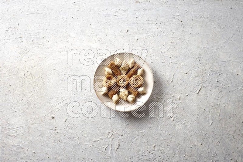 Oriental sweets in pottery plates in a light setup