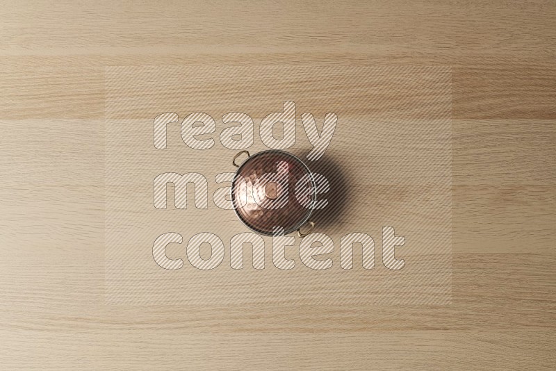 Top View Shot Of A Small Copper Pot on Oak Wooden Flooring