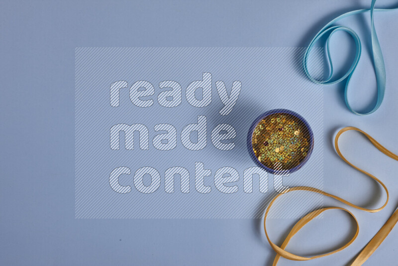 A yellow and blue collection of sewing and tailoring tools arranged on a blue background