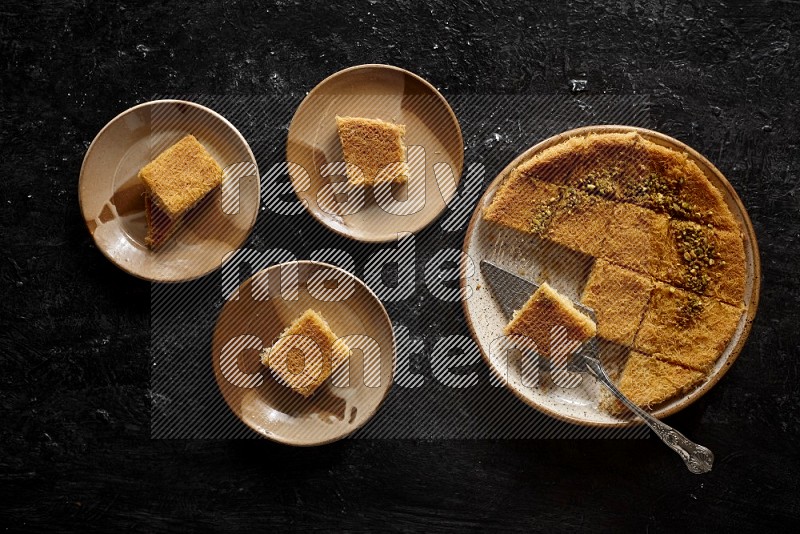 Konafa in different plates in a dark setup