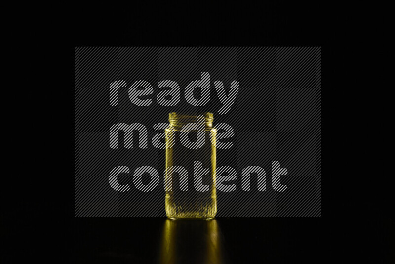 Glassware with rim light in yellow against black background