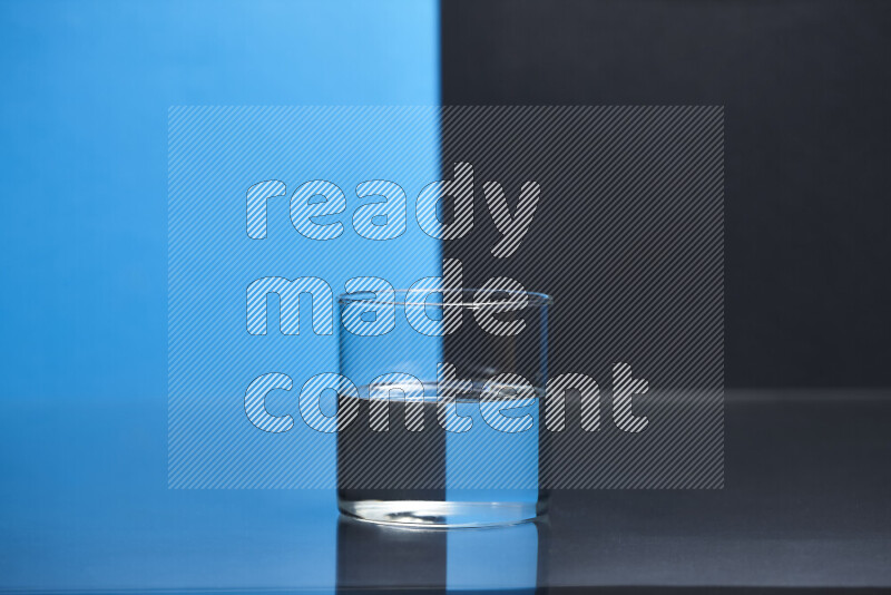 The image features a clear glassware filled with water, set against blue and black background