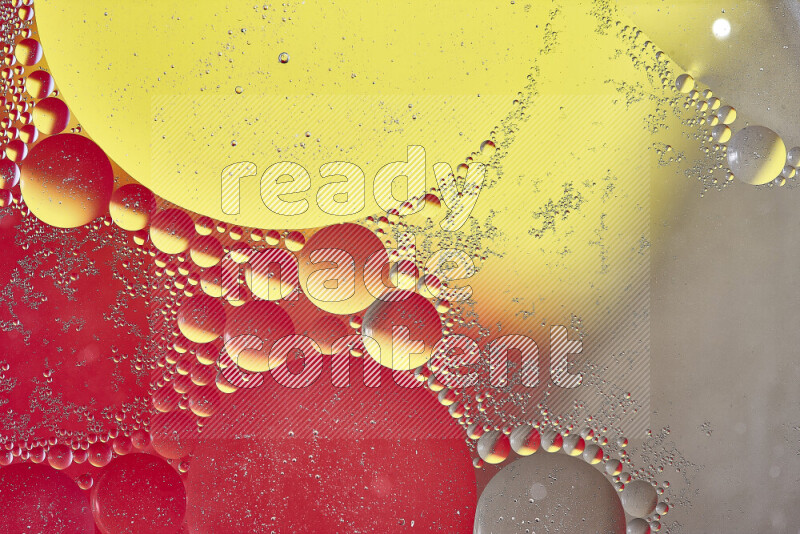 Close-ups of abstract oil bubbles on water surface in shades of yellow, red and brown