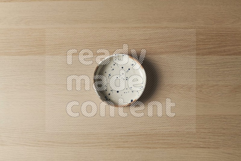 Top View Shot Of A Multicolored Pottery Bowl on Oak Wooden Flooring