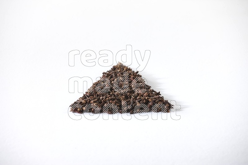cloves in a triangle shape on a white flooring