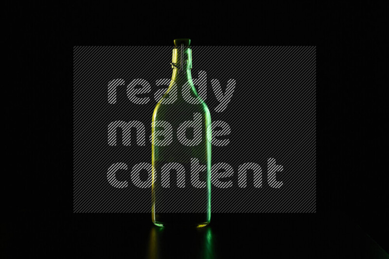 Water bottle with colored rim light against black background