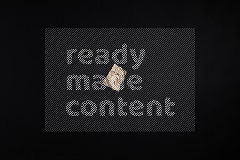 Crumpled craft paper on black background
