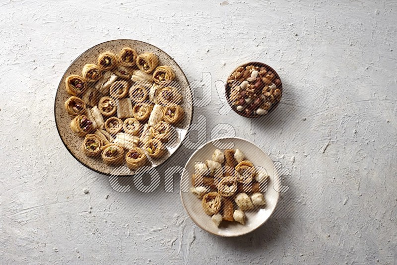 Oriental sweets in pottery plates with nuts in a light setup