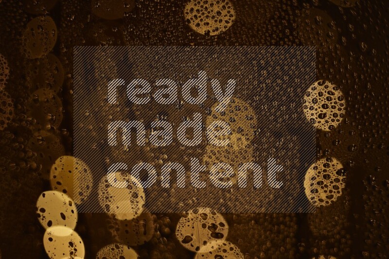 Bokeh light in yellow with water drops