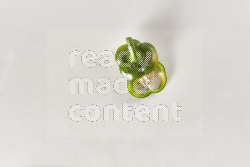 Green bell pepper slices on white background