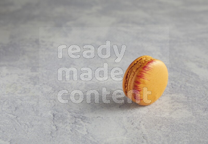 45º Shot of Orange Exotic macaron on white  marble background