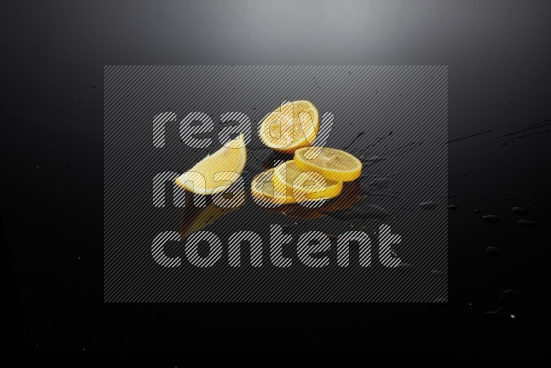 Lemon slices with water drops, and droplets on black background