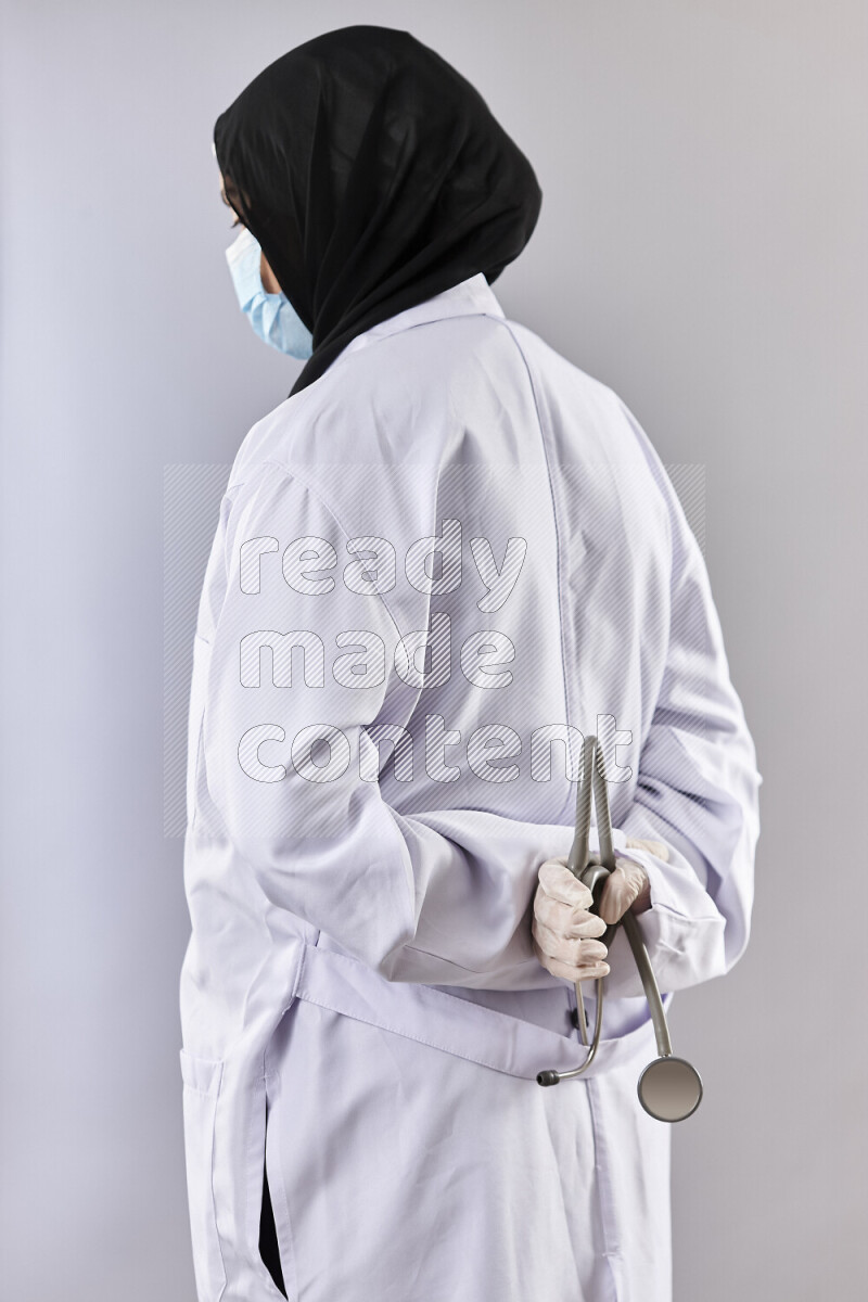 Female doctor wearing an abaya and medical attire in different positions