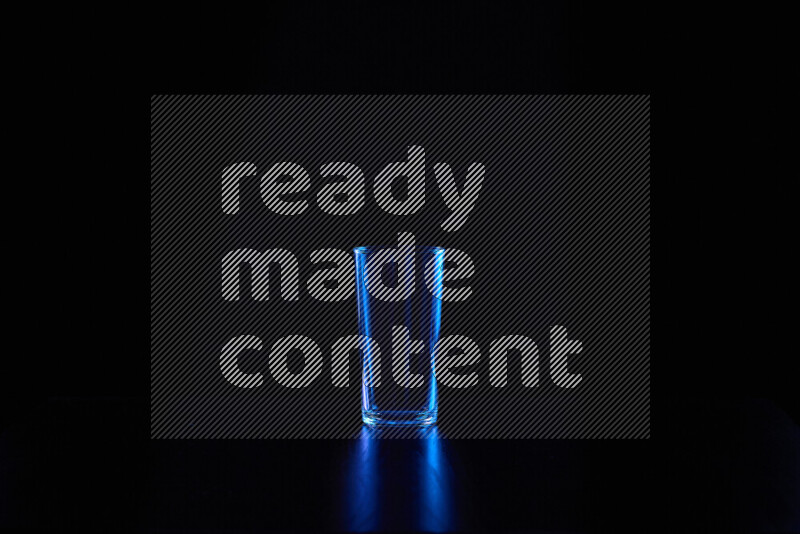 Glassware with rim light in blue against black background