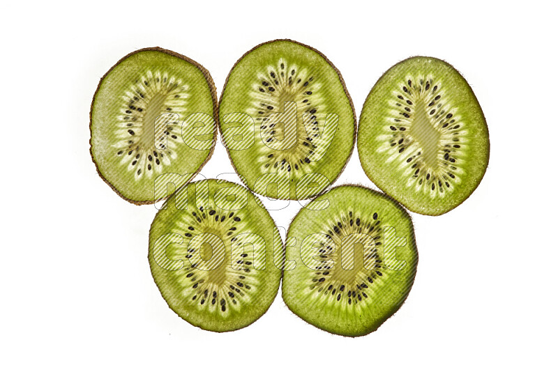 Kiwi slices on illuminated white background