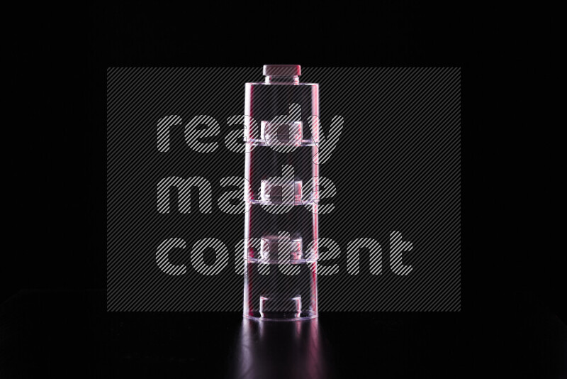 Glassware with rim light in red and white against black background