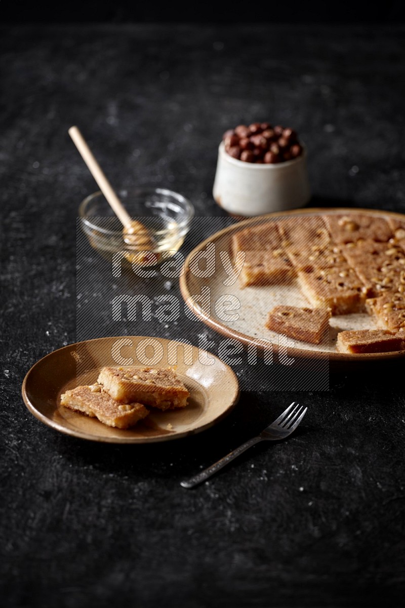 Basbousa with nuts and honey in a dark setup