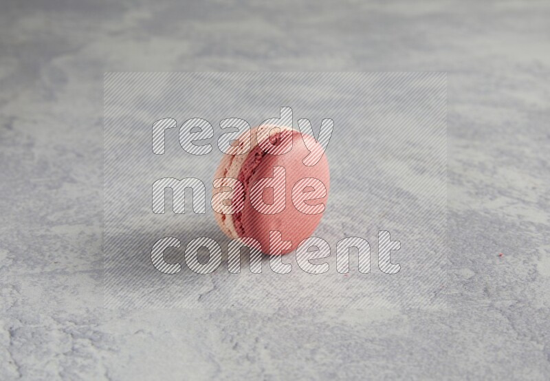 45º Shot of Pink Litchi Raspberry macaron on white  marble background