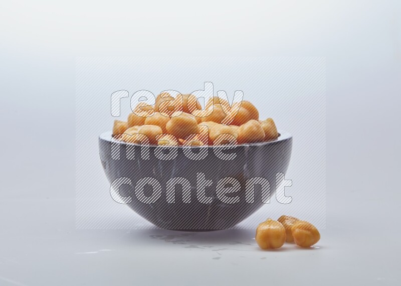 Close up of a boiled chickpeas in a container on white background