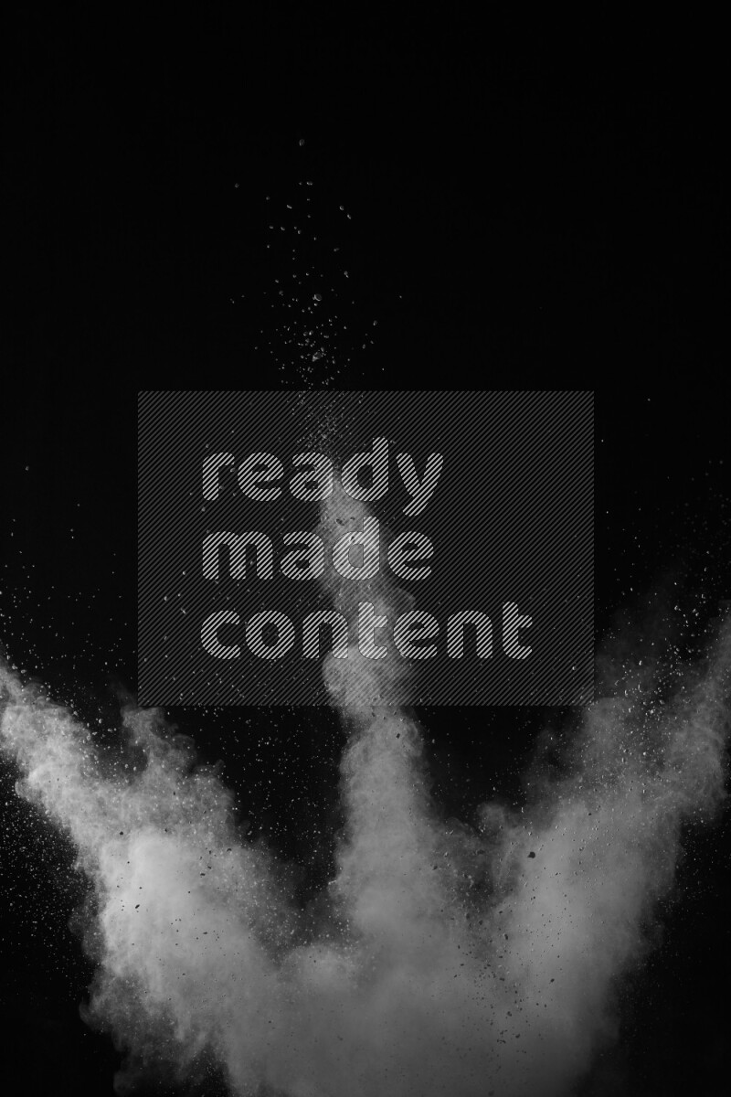 A side view of white powder explosion on black background