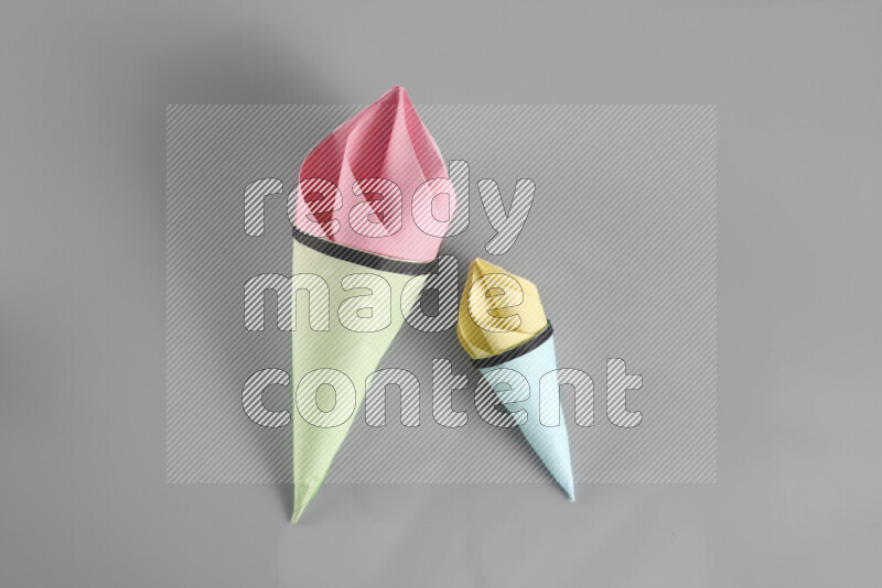 Origami ice cream on grey background